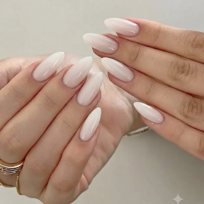 Milky nails styled on a deeper warm skin tone showing an inclusive shade match and finish
