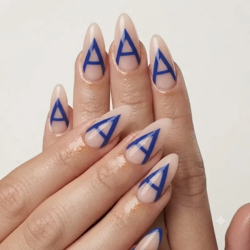 Angular triangle negative space nail design in bold colour against a sheer nude base coat