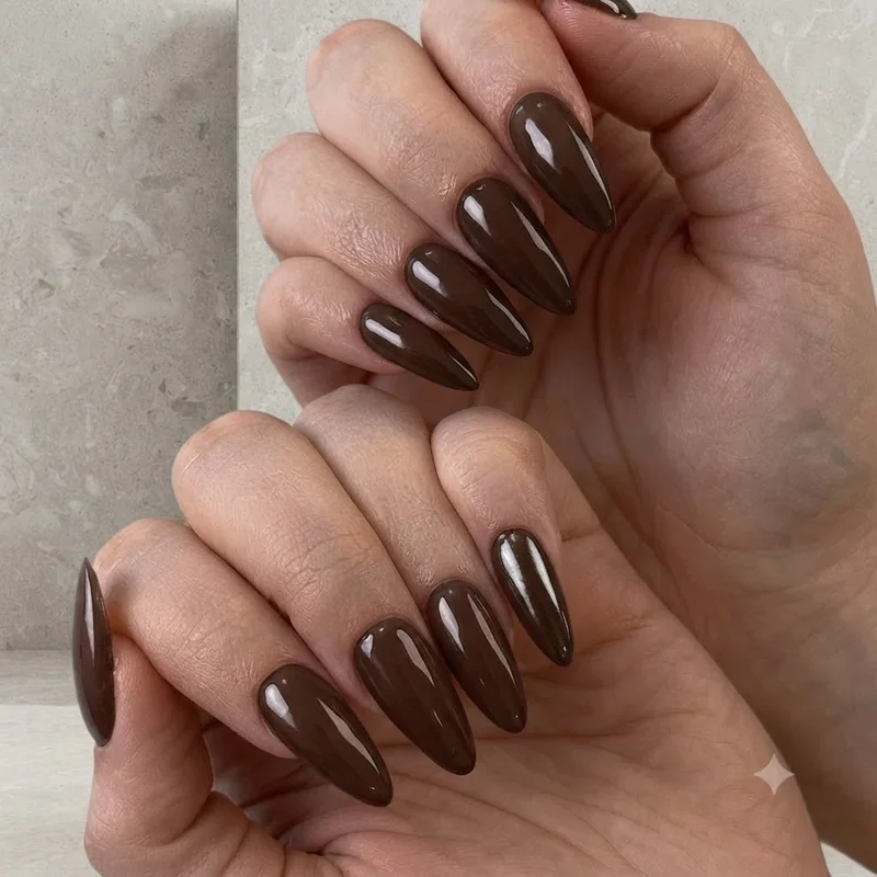 Close-up of glossy neutral one color nails in natural light, clean application