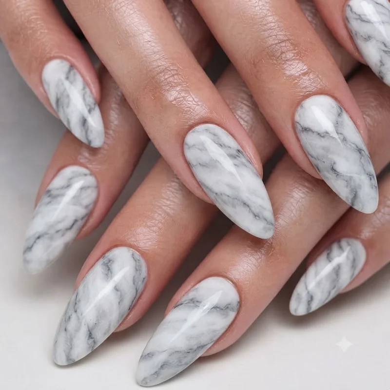 Marble effect nail art idea with swirled white and grey veining creating a natural, stone inspired manicure finish overall