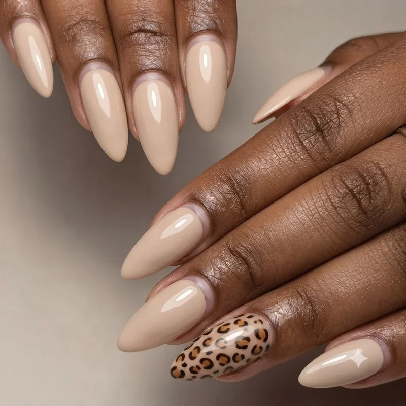 Wild animal print nail art idea featuring a miniature leopard pattern on an accent nail with a coordinating solid nail set