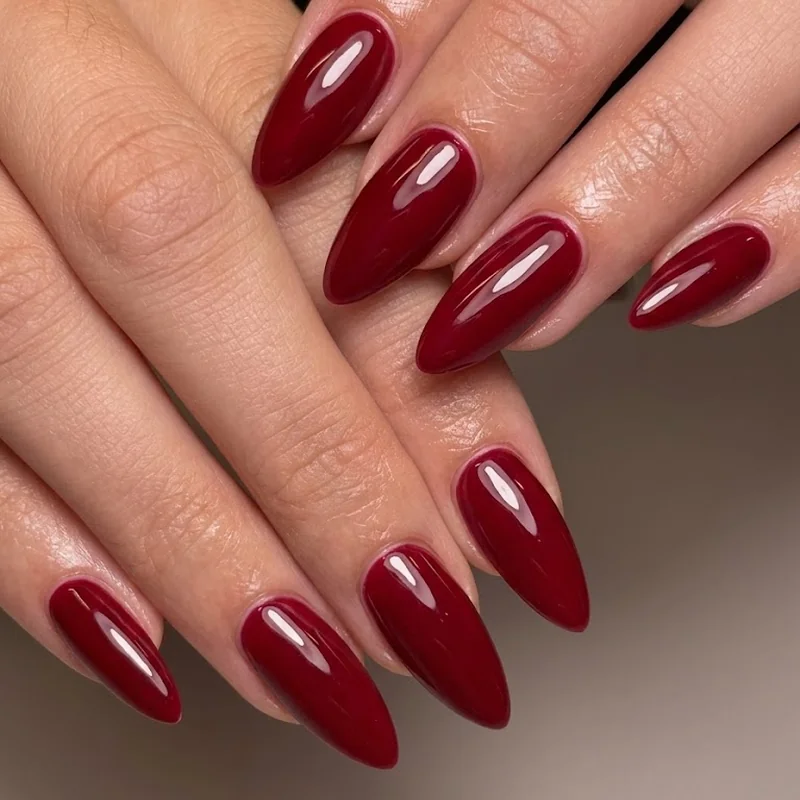 Classic red nail polish is the most popular nail color of all time in a glossy almond shape