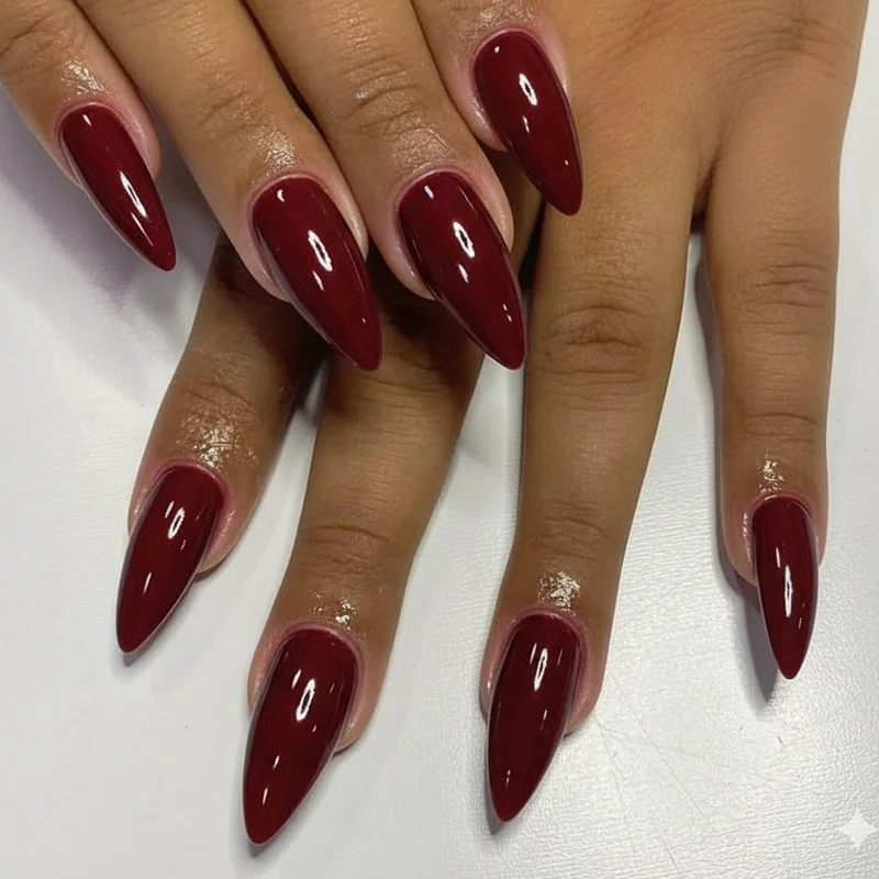 Cherry wine and deep berry nail trend 2026 showing cool-based versus warm-based red family options for different skin tones