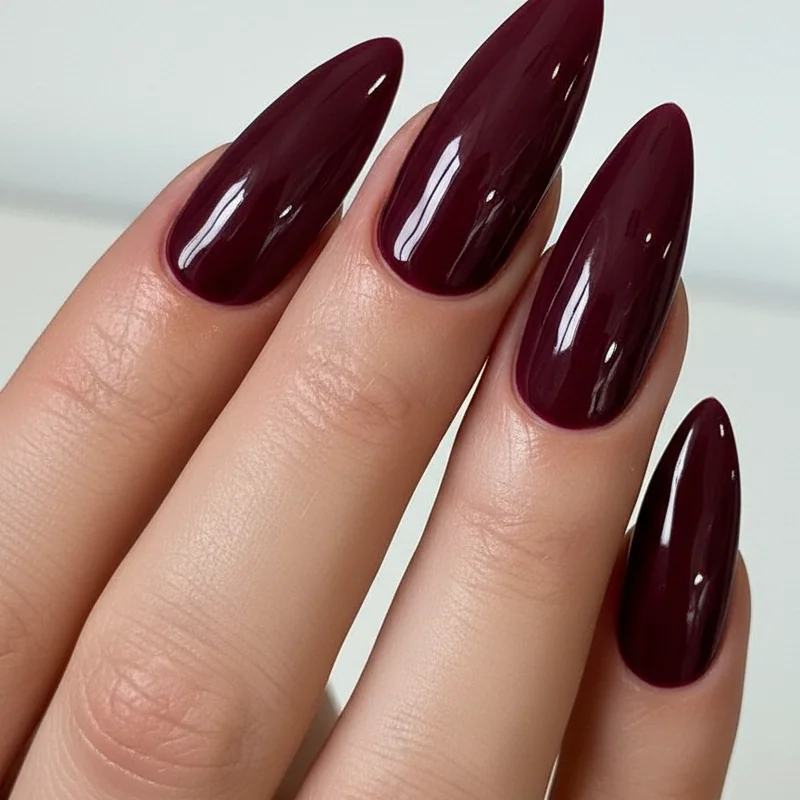 Dark nail colors on blonde hair showing deep navy plum and burgundy contrast looks against light blonde hair and fair skin tones