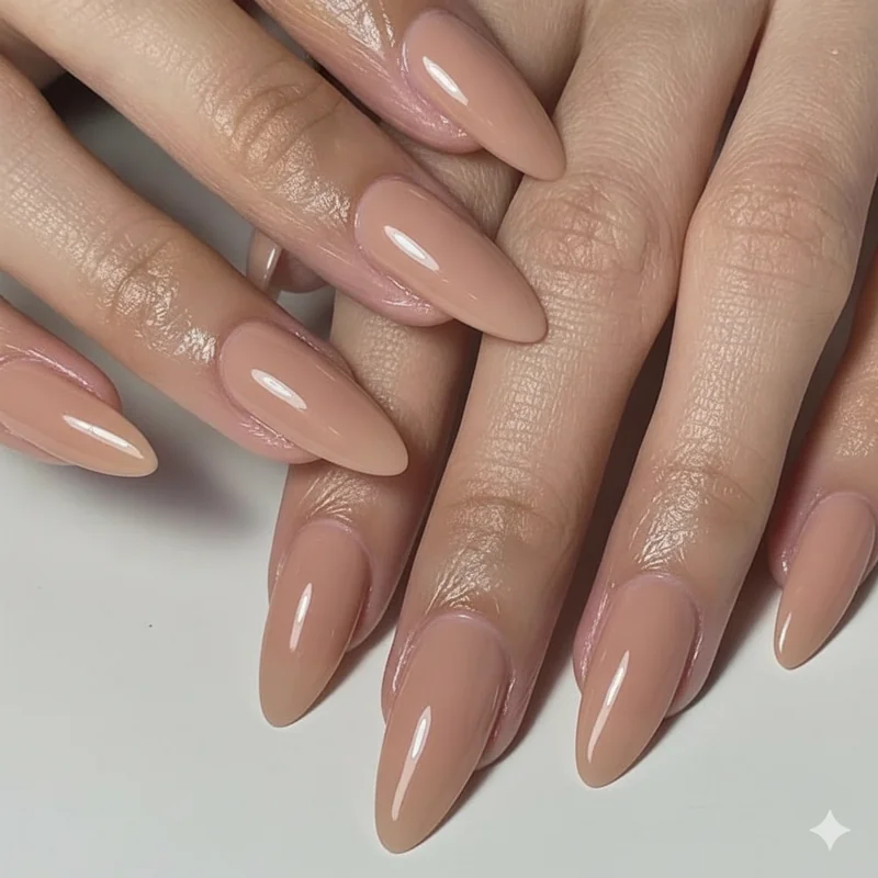 Medium length almond and oval nails on chubby fingers demonstrating flattery payoff at achievable length in warm nude tone