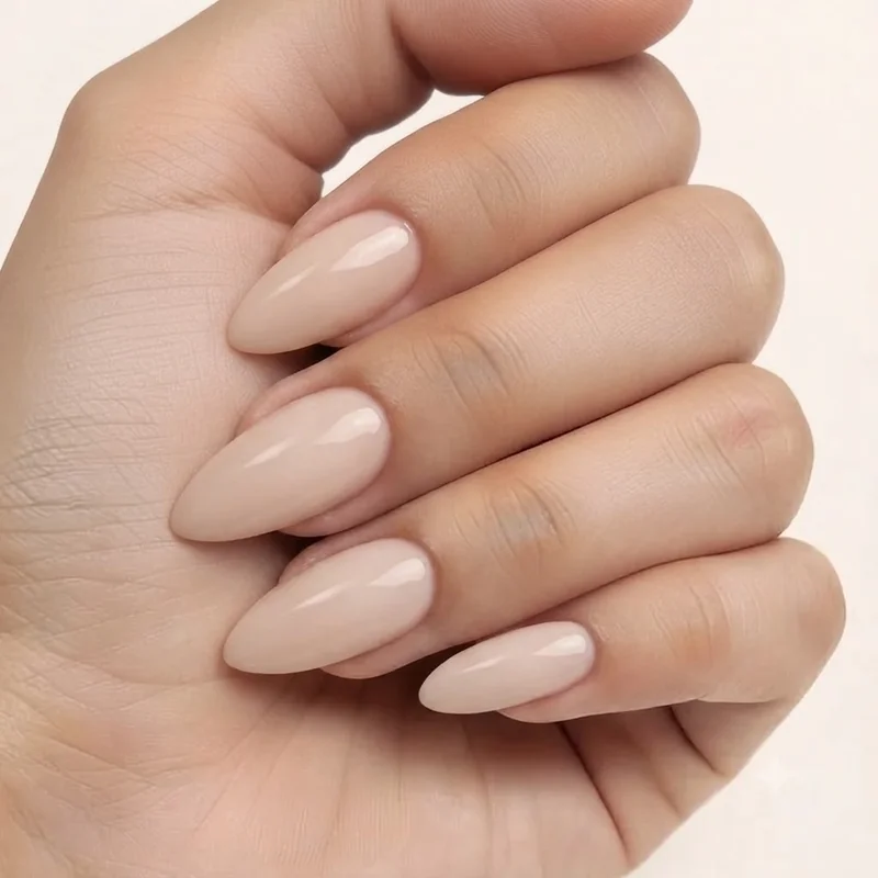 Almond nail shape ranked second most popular for 2026, styled in a quiet luxury milky nude finish for a salon manicure look