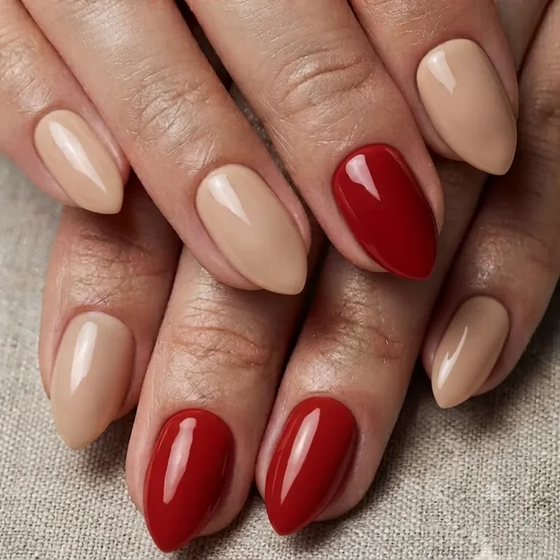 Polished short stiletto nail set in a versatile neutral and red finish for everyday wearable styling
