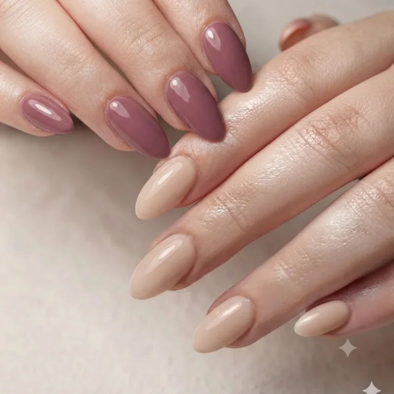 Short stiletto nails styled beside short almond shape showing the taper and point difference
