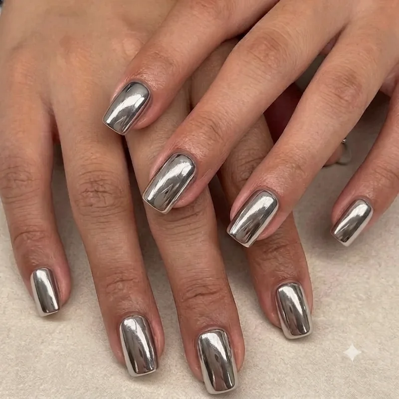 Close-up of squoval nails showing the flat top edge and softly rounded corners on clean natural nails