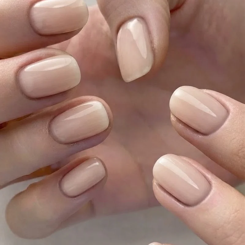 Clean short gel manicure in a natural finish prepped and ready for regular pool swimming sessions