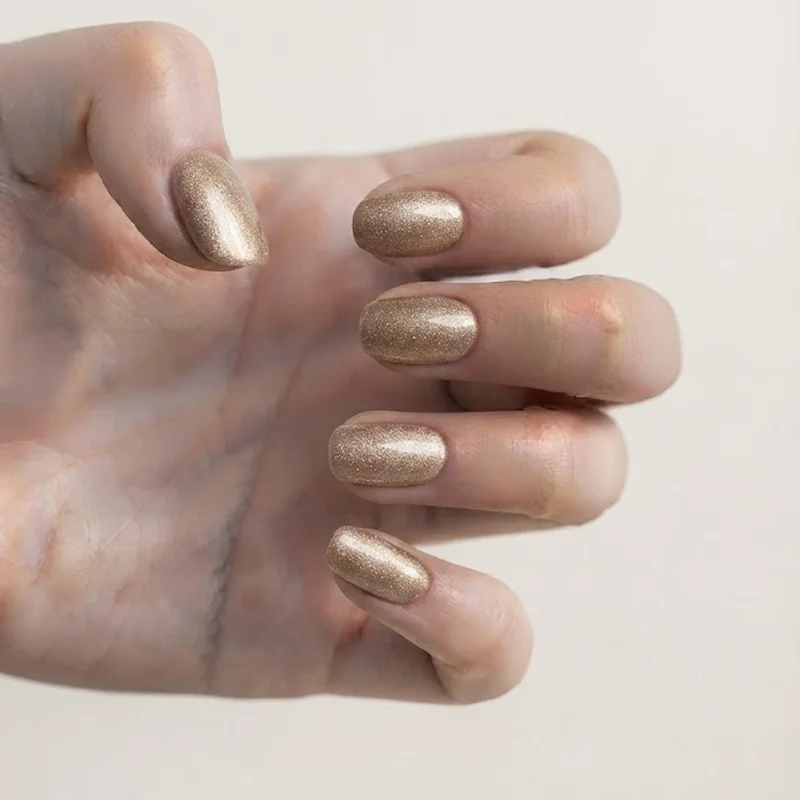 Champagne shimmer press-on nail set styled for a fast last minute NYE manicure look