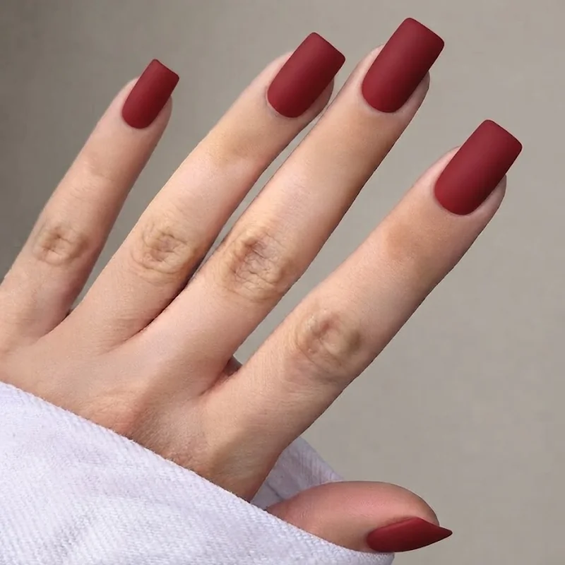 Matte red nail polish in a square shape for a modern New Year