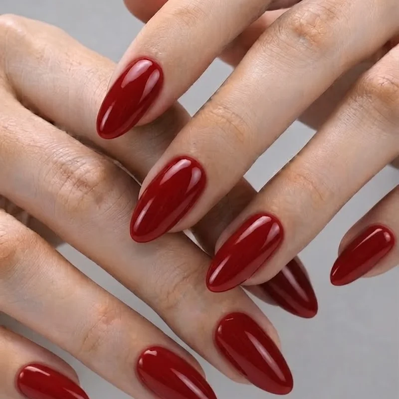 Glossy red manicure close-up during a champagne toast, red nail theory in action