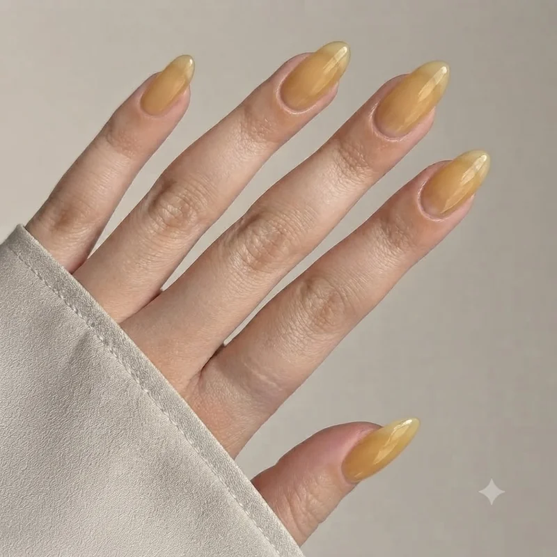 Citrine birthstone nails in sheer golden yellow jelly gel over a milky base, a subtle manicure for a november birthday party