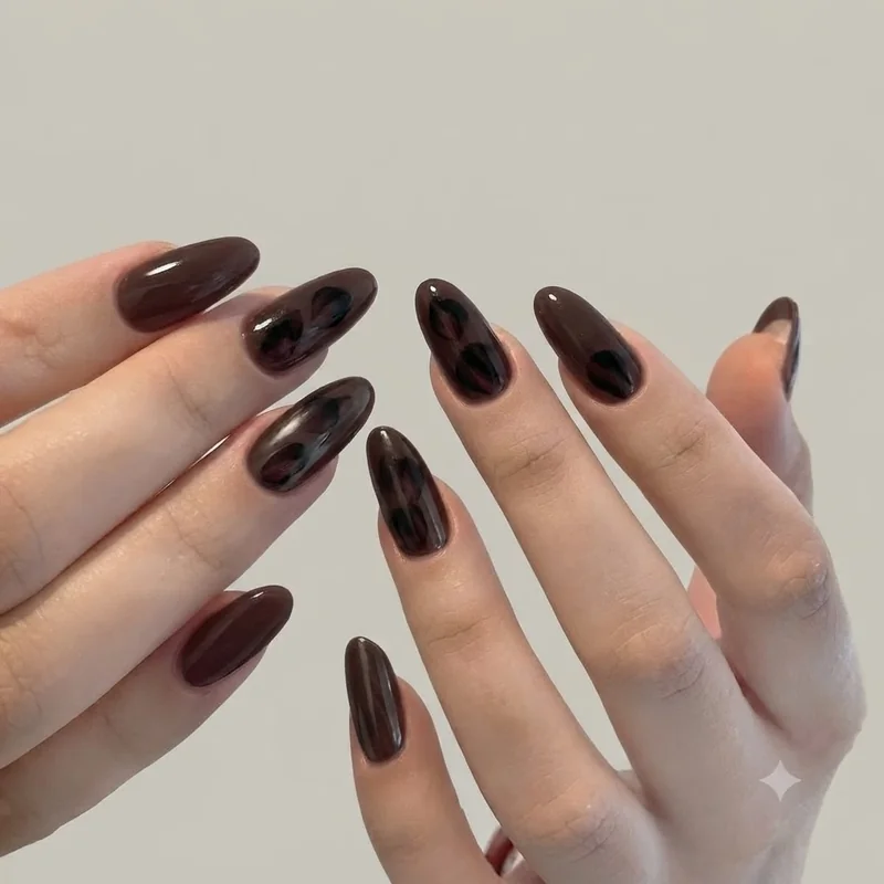 Dark floral nail art with black cherry petals over an espresso base, a tonal november nail art idea with no pumpkin motifs