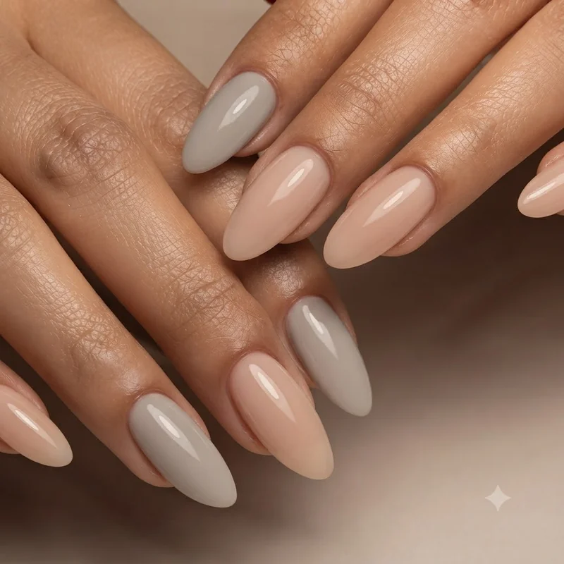 Oyster gray and bare nude soft neutral nails with a glossy top coat, a clean-girl manicure that suits a quiet november mood
