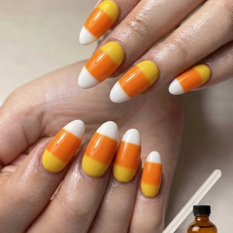 Fixing common candy corn nail mistakes with a clean up brush and acetone for crisp line correction