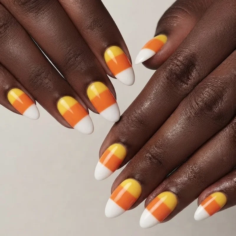 Clean tri-color striped candy corn nails achieved using the beginner tape method technique