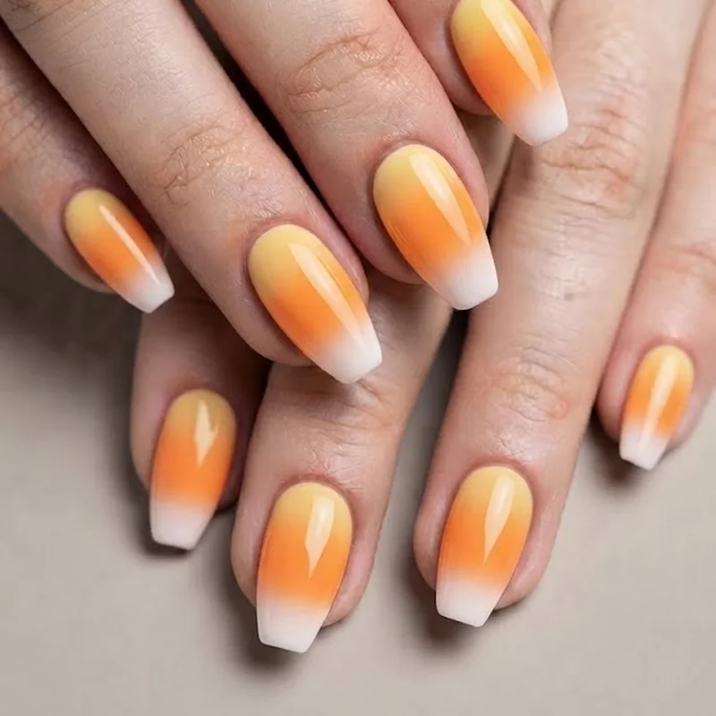 Sponge gradient candy corn nails with smoothly blended yellow orange and white color transition