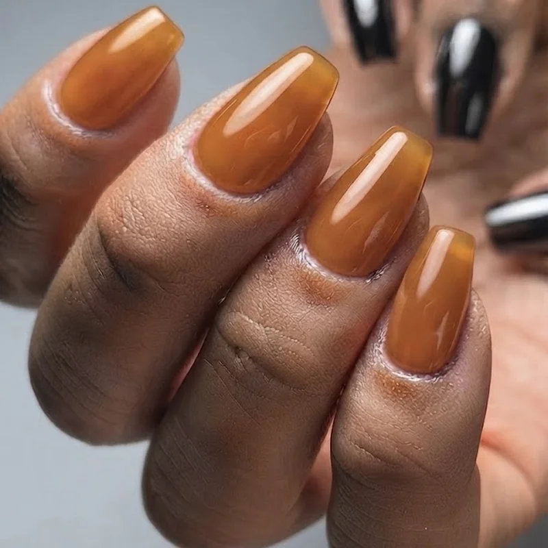 Jelly amber daytime birthday nails contrasted with chrome black night out October manicure