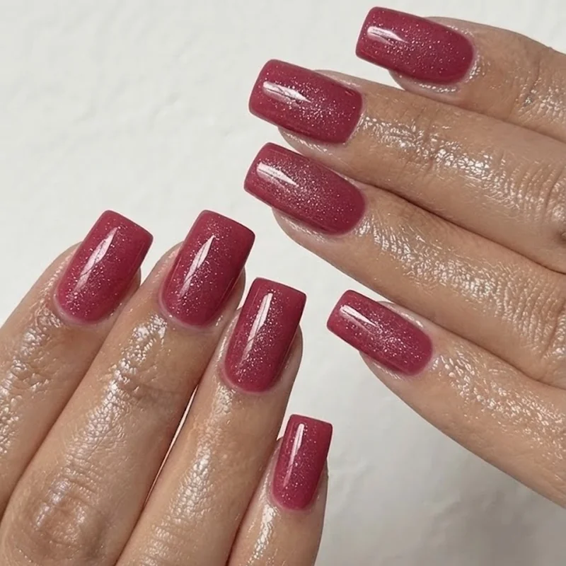 Classic pink tourmaline manicure in glossy finish on square shape nails with subtle glitter