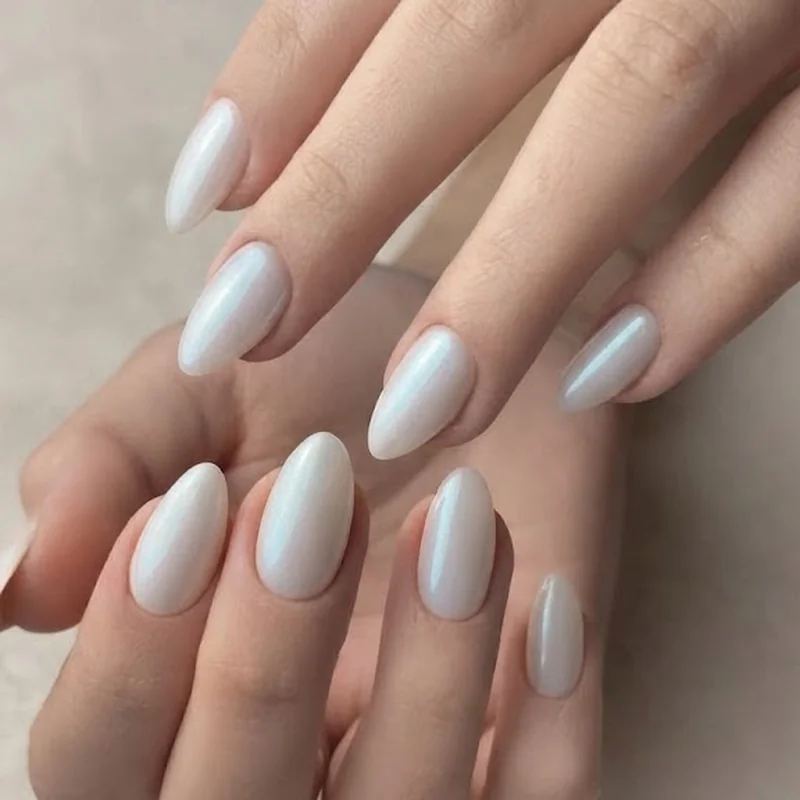 Milky pearlescent opal nail design in almond shape with soft color shift under studio lighting