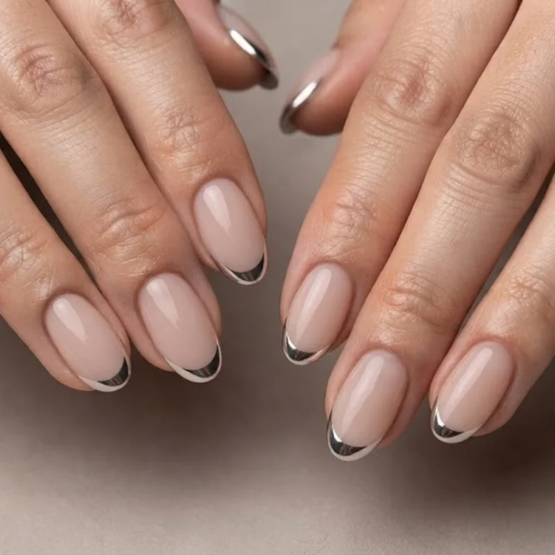 Short almond nails with micro french tip variation in chrome finish for autumn