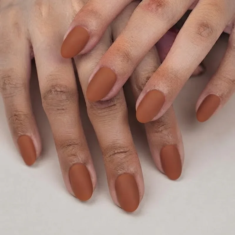 Short almond october nails in matte cinnamon brown polish, clean single manicure look