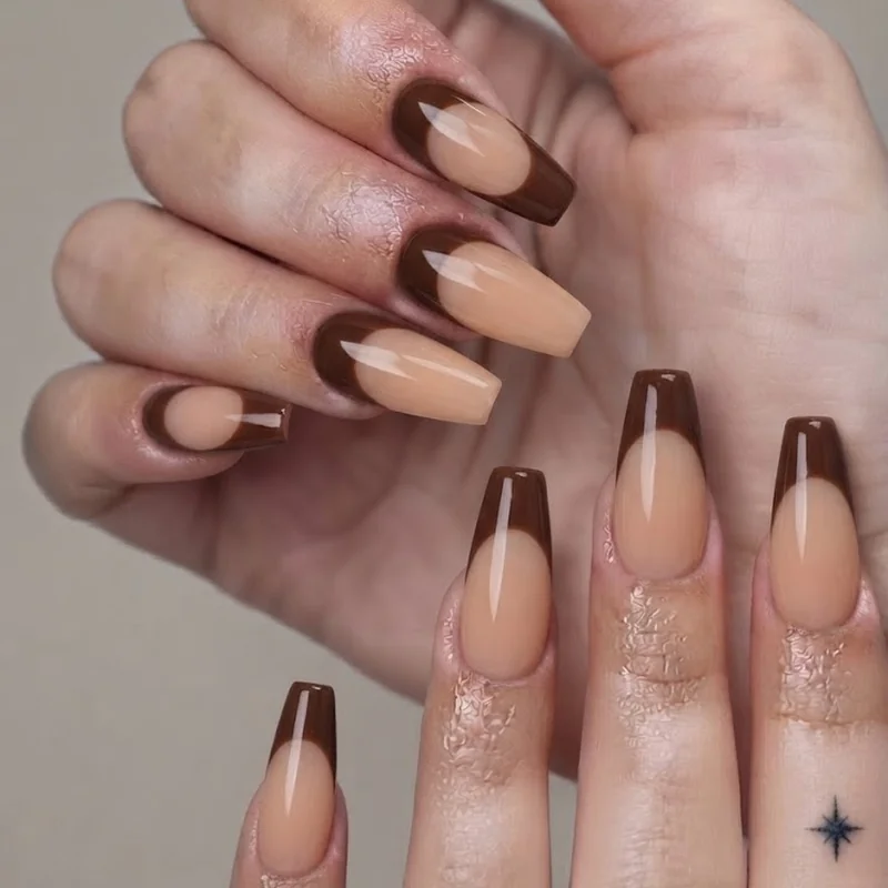 Short coffin october nails in chocolate brown with reverse french manicure detail