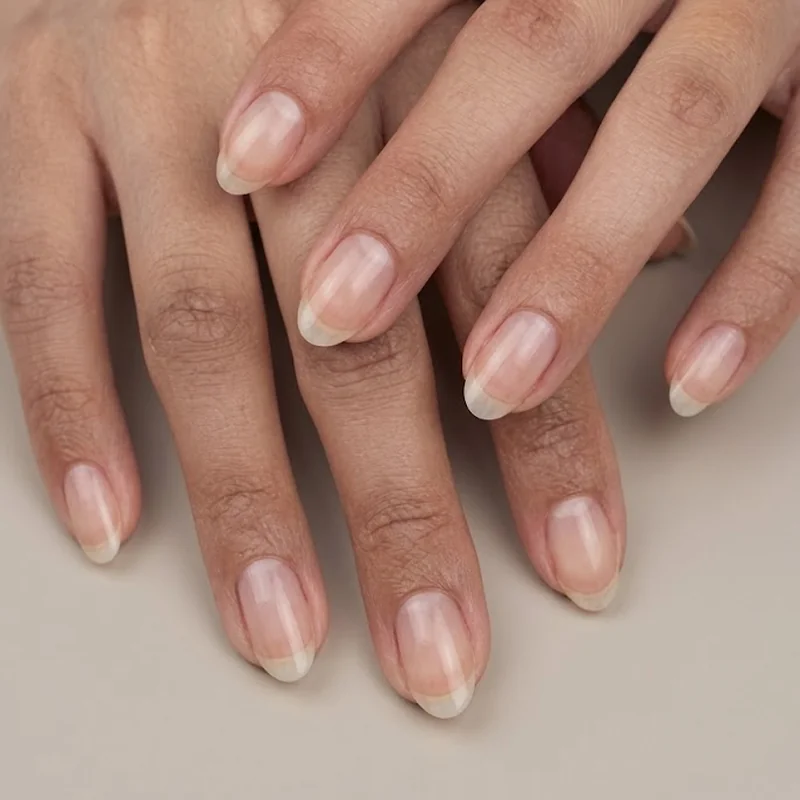 Nail file angled inward toward center showing correct oval shaping direction on natural nail