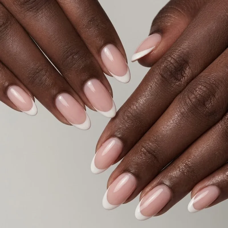 Classic milky white oval french tip nails on a sheer pink nude base manicure