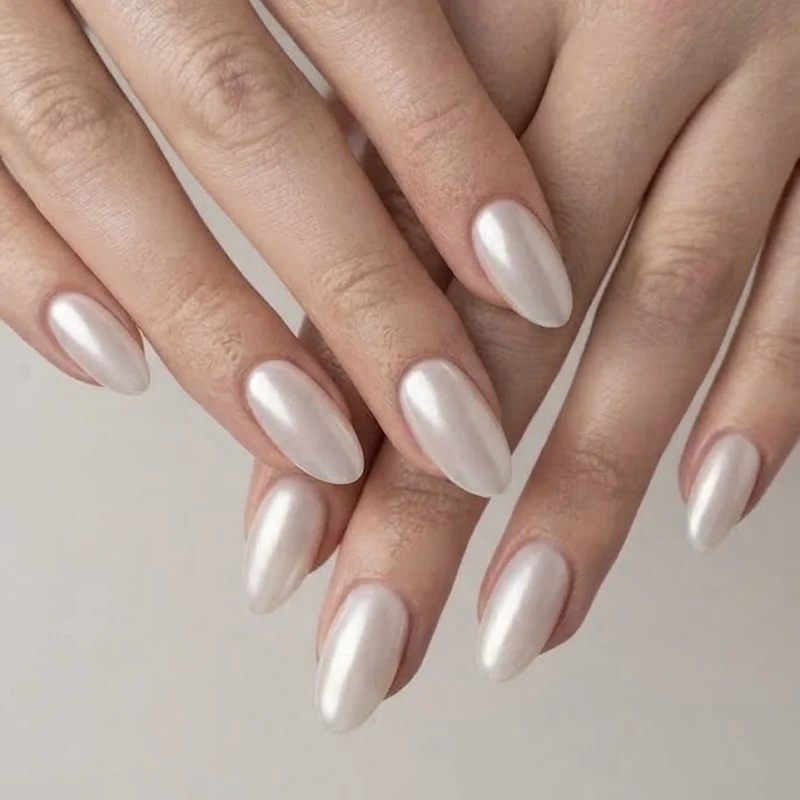 Oval nails styled in milky white sheer chrome finish reflecting the 2026 quiet luxury manicure trend