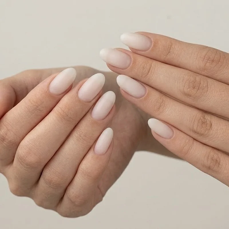 Milky cloud white oval nails soft finish manicure in quiet luxury color palette