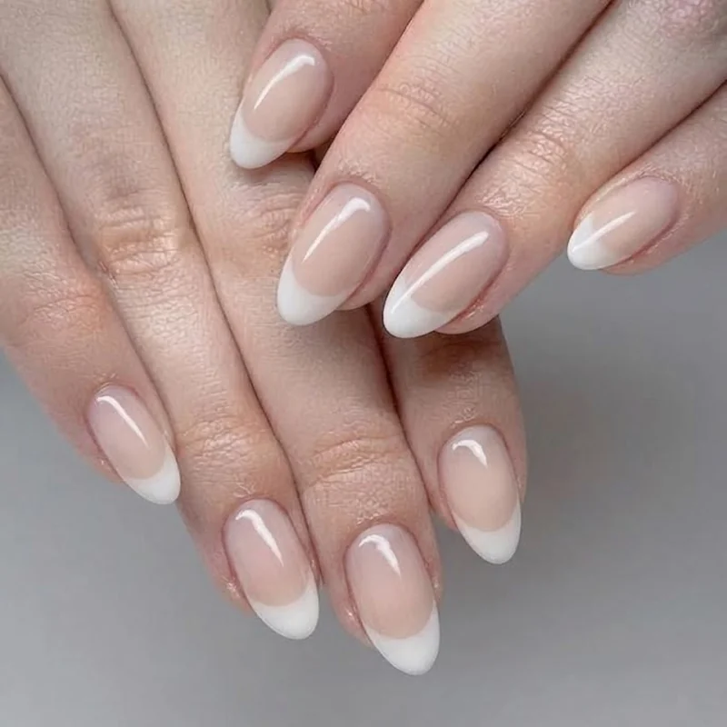 Milky French tip and ombre oval nail trend look with soft neutral color fade
