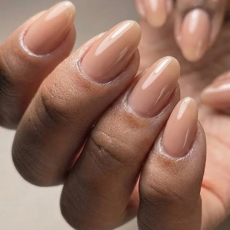 Nude quiet luxury oval nails manicure with glossy finish and rounded tip shape