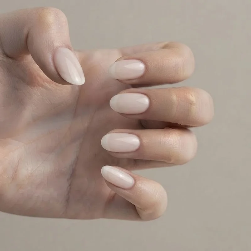 Oval vs round nails 2026 trend showing quiet luxury milky white sheer nude editorial manicure look