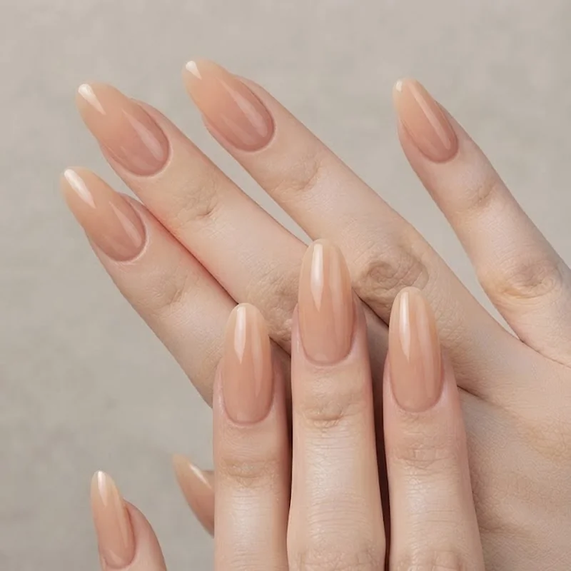 Round nails on wide nail bed short fingers showing natural elongation effect with nude polish