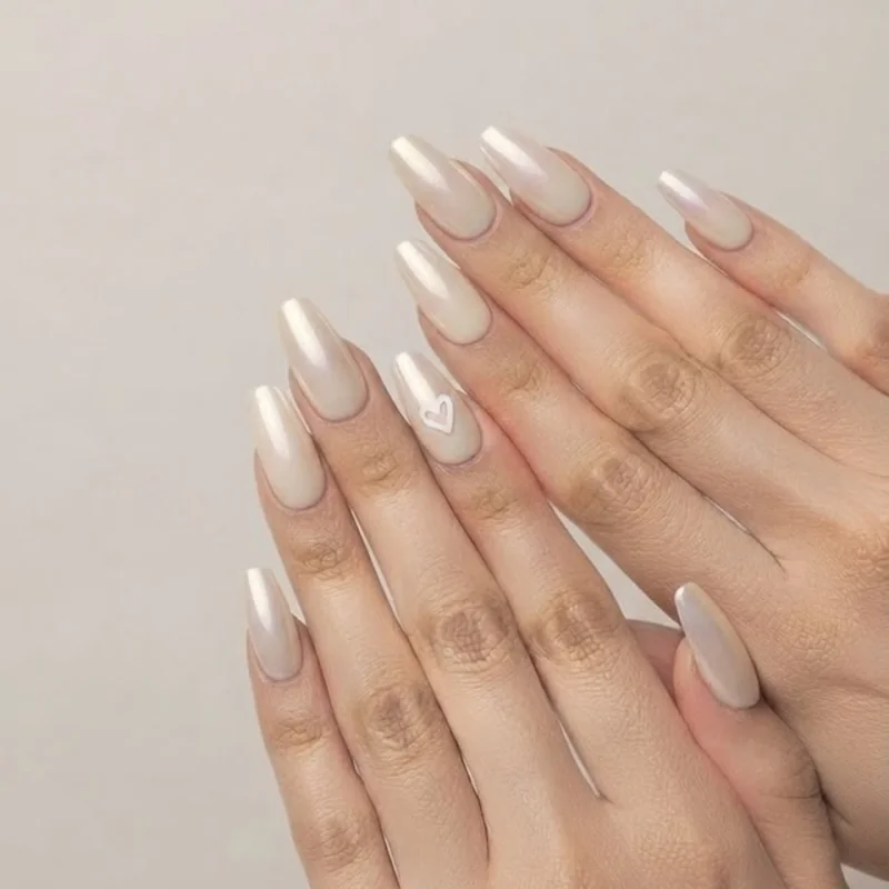 Pearl chrome ombré nail design with a cream to pearl gradient transition on medium length almond nails