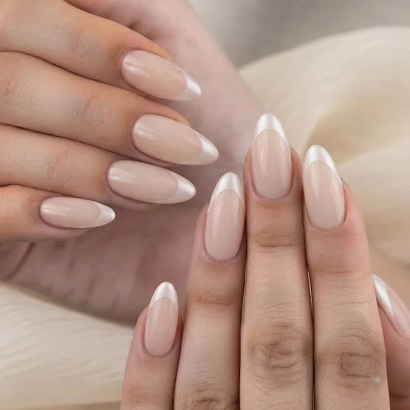 Pearl french tip bridal manicure with soft iridescent white tips styled for a wedding day look