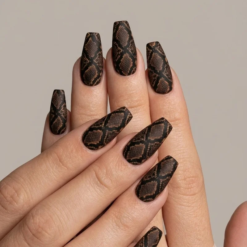 Classic brown and black snake print nails on coffin shape with matte finish and caramel highlights