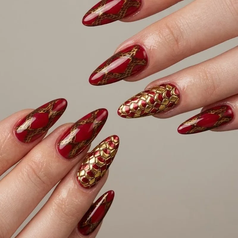 Lunar New Year snake print nails in red and gold with accent nail scale detailing on ring finger