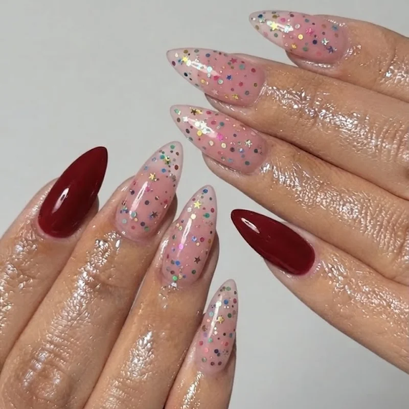 Long decorated femmicure nail set showing alternative to short queer manicure style