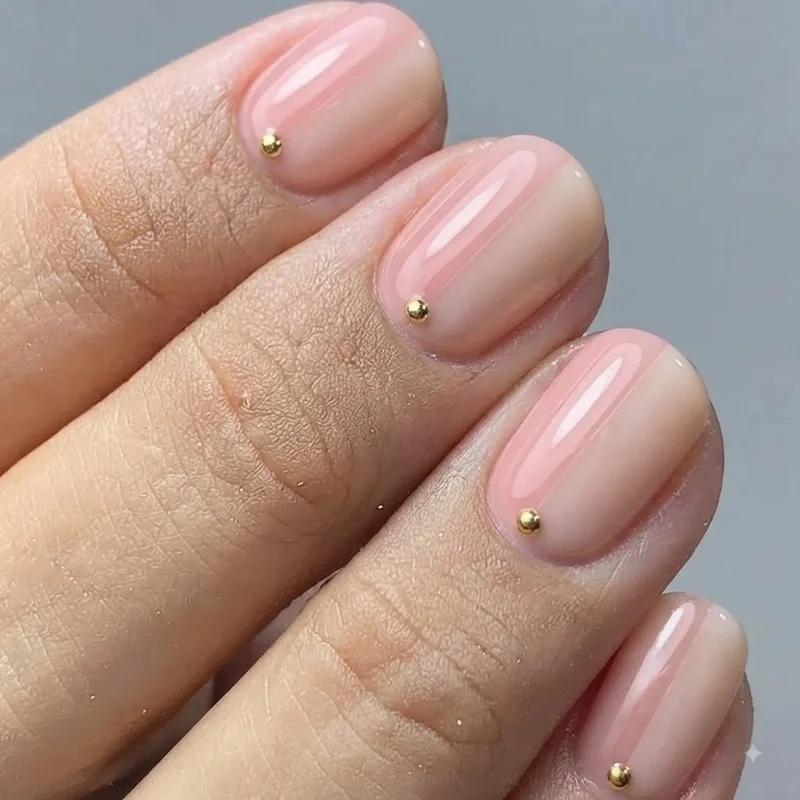 Soap-pink and milky nude nail colour swatches shown side by side on natural short nails