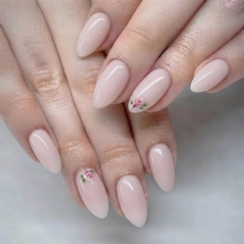 Beginner dotting tool rose accent nail on a pastel pink base coat manicure