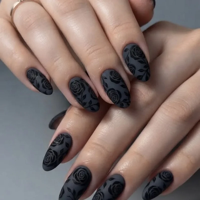 Dramatic black rose nail design on a dark base with matte top coat finish for bold looks