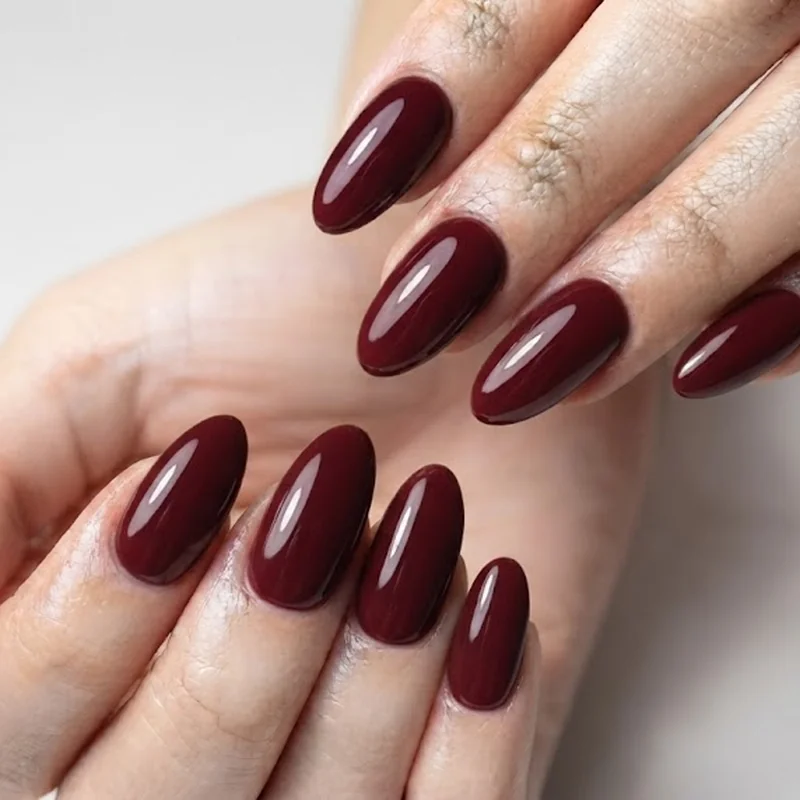 Glossy burgundy late september nails on almond shape with salon finish