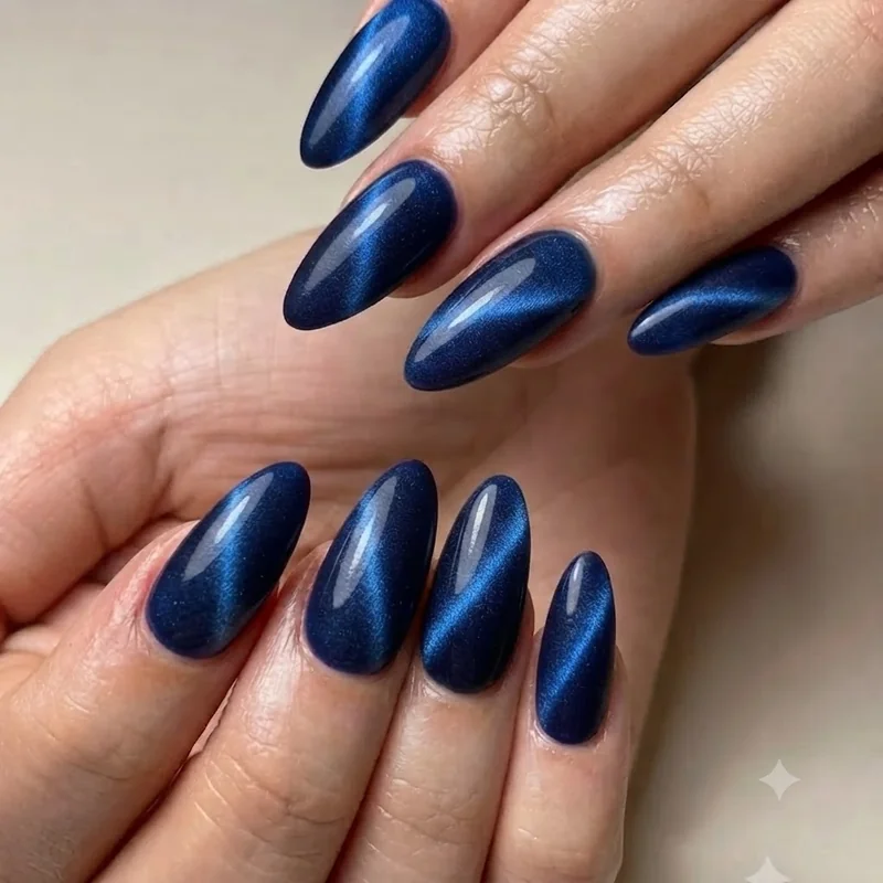 Close up of september birthday nails cat-eye technique showing magnetic sapphire stripe detail