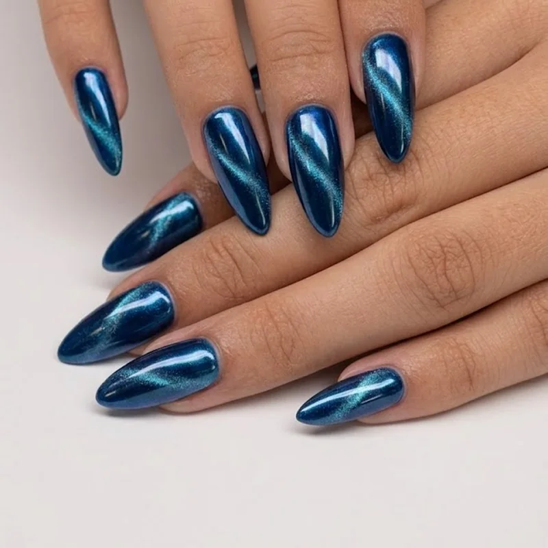 Chrome powder and cat-eye gel metallic manicure over jewel-tone base for september nail art