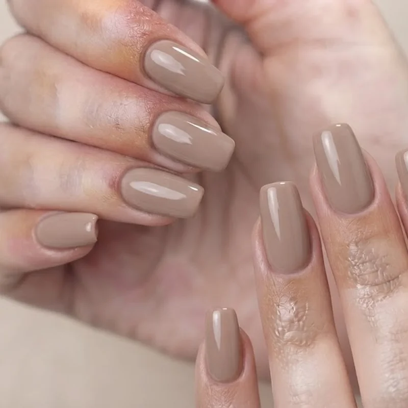 Short squoval September manicure in a warm early fall neutral shade with clean finish
