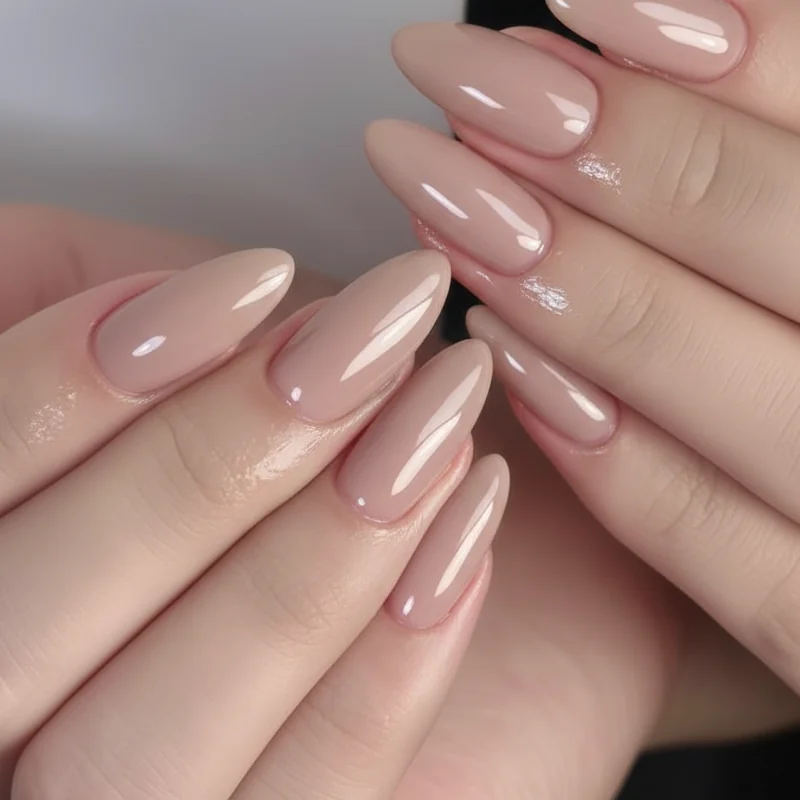 Short almond nails maintenance routine showing cuticle oil application and top coat refresh for salon fresh home care